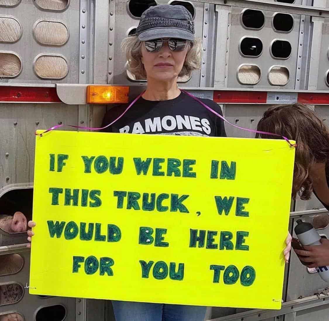 Activist at a vigil with a sign reading 'We would be here for you too'